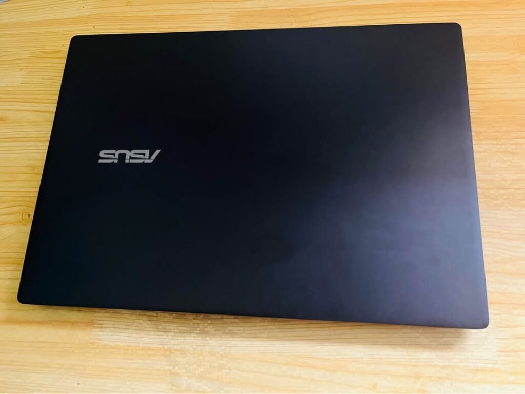 Top view of ASUS V16 laptop showing minimalist matte black lid design