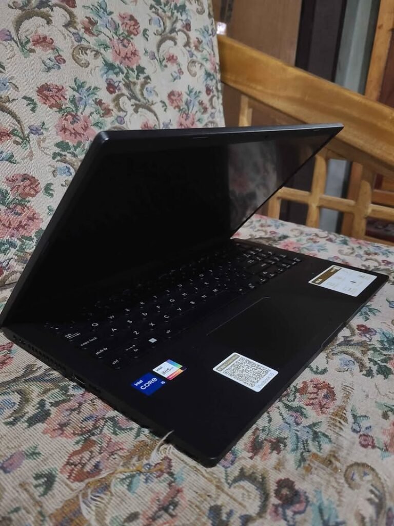 Side angle view of ASUS Vivobook 15 Intel Core i5 13420H 13th Gen laptop showing slim profile, backlit keyboard, and modern matte finish design