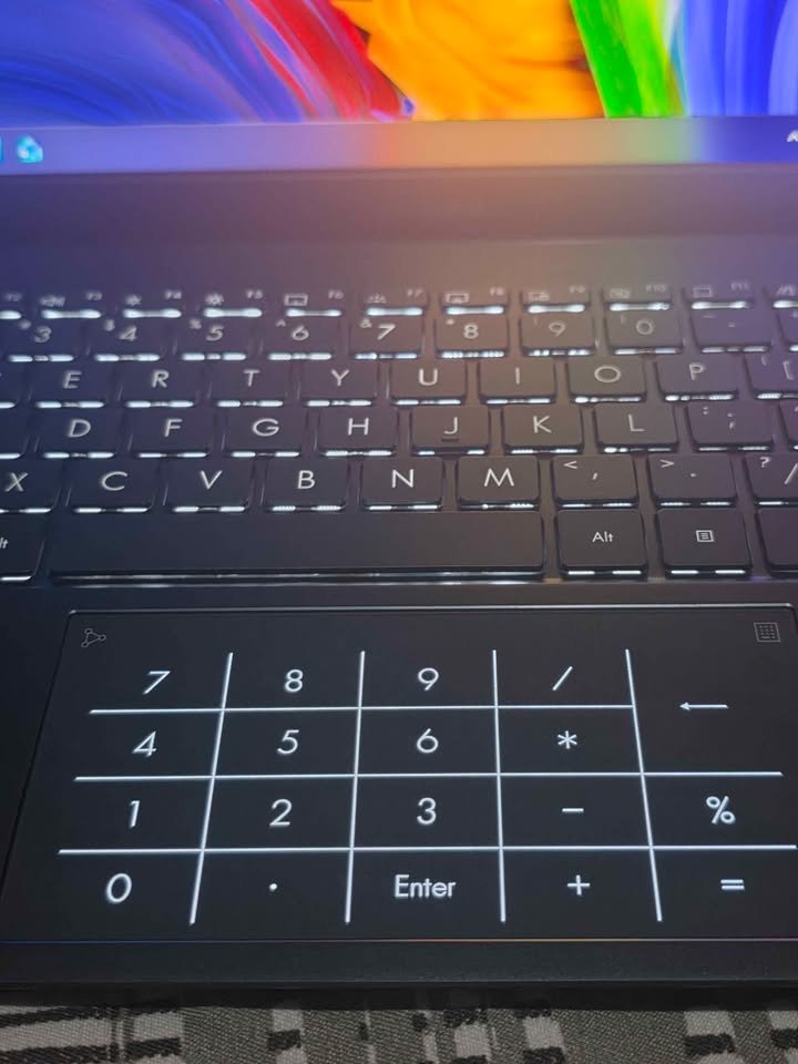 Close-up of ASUS Zenbook 14 backlit keyboard with NumberPad numeric keypad on the touchpad