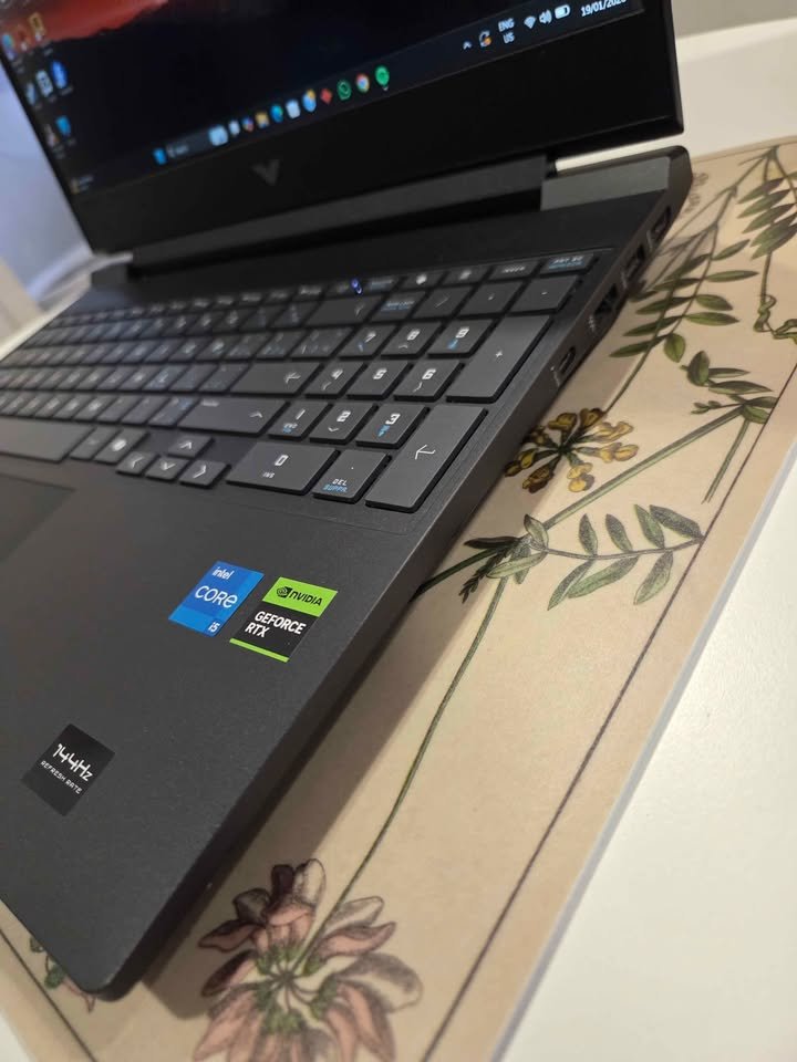 HP Victus laptop angled view highlighting keyboard, USB ports, and RTX GPU branding