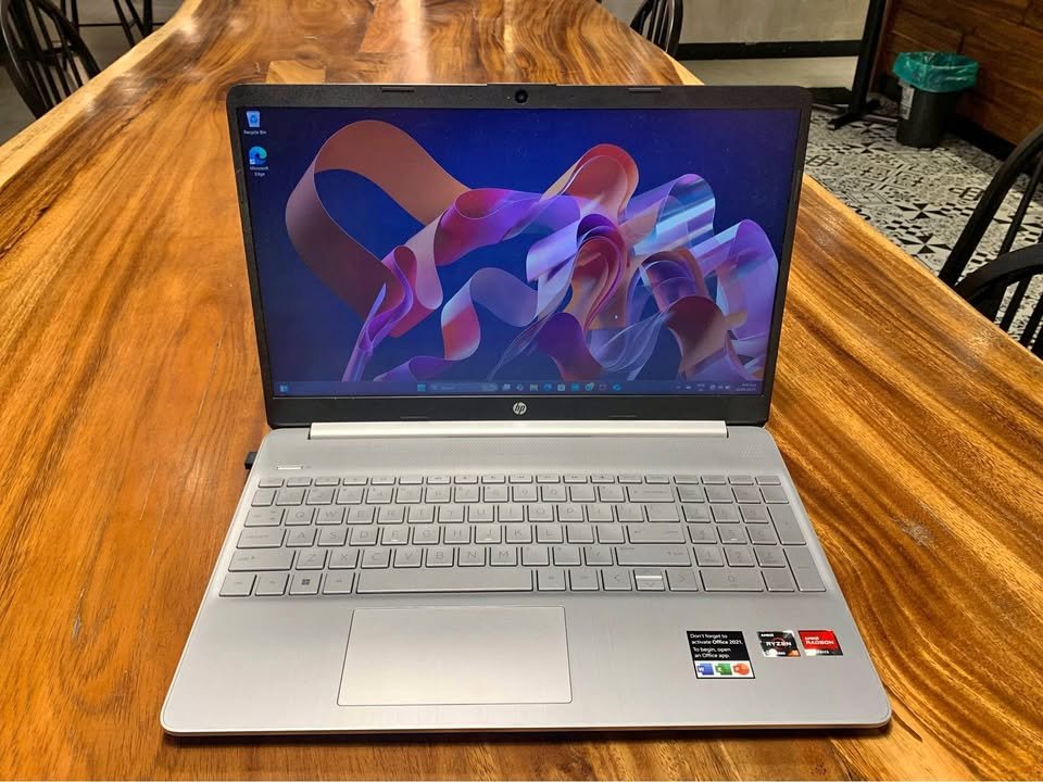 Front view of HP 15 AMD Ryzen 7 5825U laptop showing large display, thin bezels, and durable silver chassis