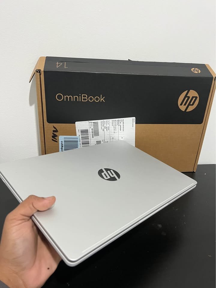 Back panel of a silver HP OmniBook 14 laptop showing the centered HP logo and slim aluminum lid design