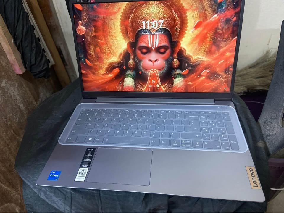 Close view of Lenovo IdeaPad Slim 3 laptop showing keyboard, touchpad, and screen brightness level