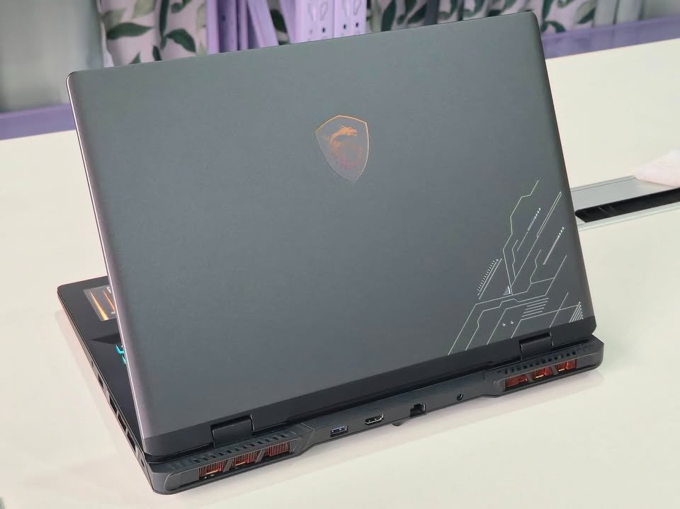Rear view of MSI gaming laptop showing back panel design, cooling vents, and MSI dragon logo
