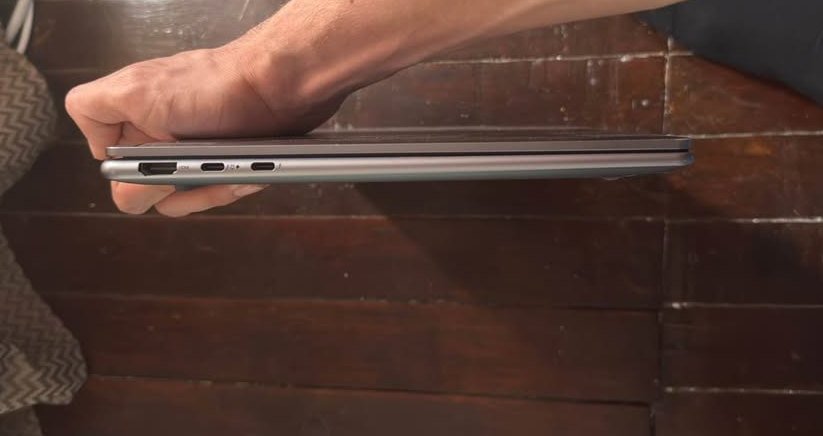 Lenovo Yoga Slim 7 laptop left side view showing USB-A port, two USB-C Thunderbolt ports, and slim aluminum chassis